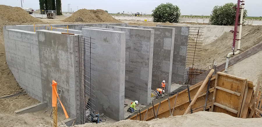 Work progresses on the construction of a pumping station that will house four 450-horsepower pumps capable of pumping a total of 500 cubic feet/second into canals heading north and east. 