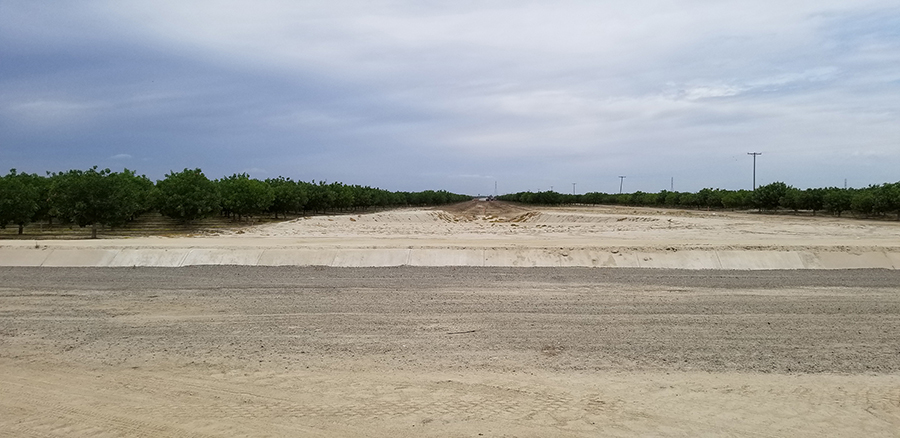 Looking north, the canal extension will run a total of 1.5 miles and connect in the future to additional phases of the McMullin On-Farm Flood Capture and Recharge Project. The property shown is a Terranova Ranch pistachio orchard. Trees were removed for canal construction through the right of way. “It was sad to have to take them out, but we know in the long run, the water is more valuable,” said ranch manager Don Cameron. 