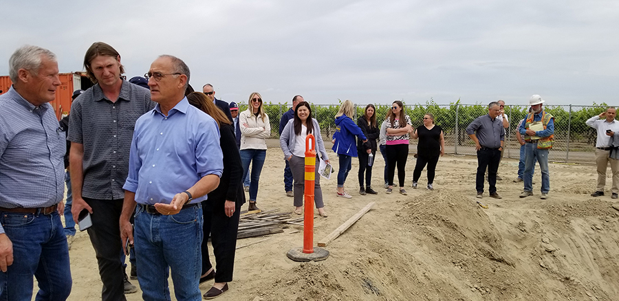 Terranova Ranch manager Don Cameron, left, talks to California Water Commission Chairman Armando Quintero, third from left, during a tour of the McMullin On-Farm Flood Capture and Recharge Project.