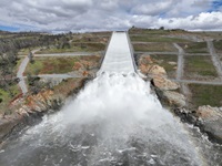 A drone provides an aerial view of the small cloud mist formed as water flows over the four energy dissipator blocks at the end of the Lake Oroville main spillway. The California Department of Water Resources increased the water release down the main spillway from 4,000 cubic feet per second (cfs) to 8,000 cfs. Main spillway releases will continue to manage lake levels in anticipation of rain and snowmelt. Photo taken March 10, 2023.