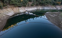 A drone photo shows the California Department of Water Resources’ Juvenile Salmonid Collection System (JSCS) Pilot Project — in partnership with NOAA Fisheries, the California Department of Fish and Wildlife, the Winnemem Wintu Tribe and others — in the upper McCloud Arm of Shasta Lake in Shasta County, California. Photo taken November 8, 2023.