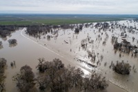 A drone view of floodwaters from the Sacramento River overtopping the Fremont Weir in Yolo County, California. 