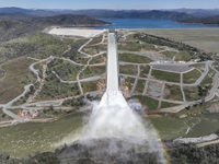 A drone provides an aerial view of a cloud mist formed as water flows over the four energy dissipater blocks at the end of the Lake Oroville Main Spillway.