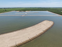 A drone photo of water diverted onto a newly constructed groundwater recharge basin at Mountain View and Temperance near Selma in Fresno County, California. Photo taken May 13, 2024.