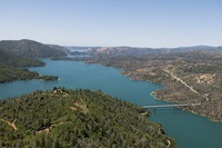 An aerial view shows high water conditions at Enterprise Bridge located at Lake Oroville in Butte County, California. Photo taken May 20, 2025.  On this date, the water storage was 3,400,147 acre-feet (AF), 99 percent of the total capacity.  Nick Shockey / California Department of Water Resources