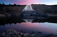 Newly installed lighting illuminates Oroville Dam’s main spillway at sunrise during a continuous 24-hour period as part of activation testing. 