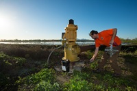 engineering geologist with the California Department of Water Resources, measures the water depth at specific agricultural wells in Colusa County on March 17, 2016. 