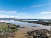 A drone view of floodwaters from the Sacramento River overtop the Colusa Weir in Colusa County, California, after an atmospheric river storm dumped water across much of the state. Photo taken February 6, 2024.